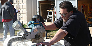 Construction student using a chop saw.
