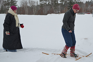 Women snowshoeing through thick snow.